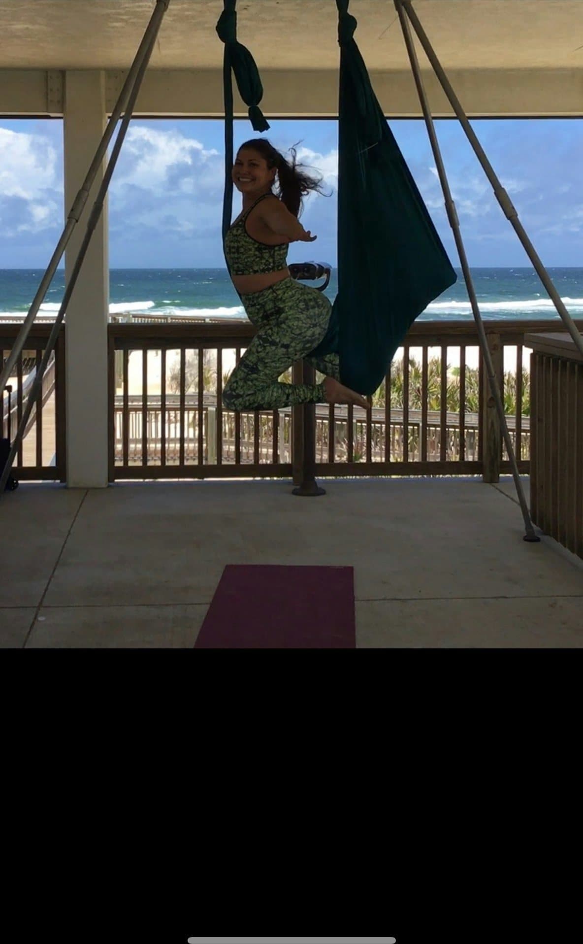 A student working in a hammock on the upstairs pavilion deck above the dunes