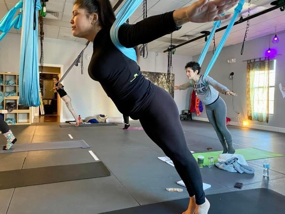 Standing split with one foot hooked in the hammock